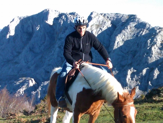  Man doing a horseback riding route in the mountains 